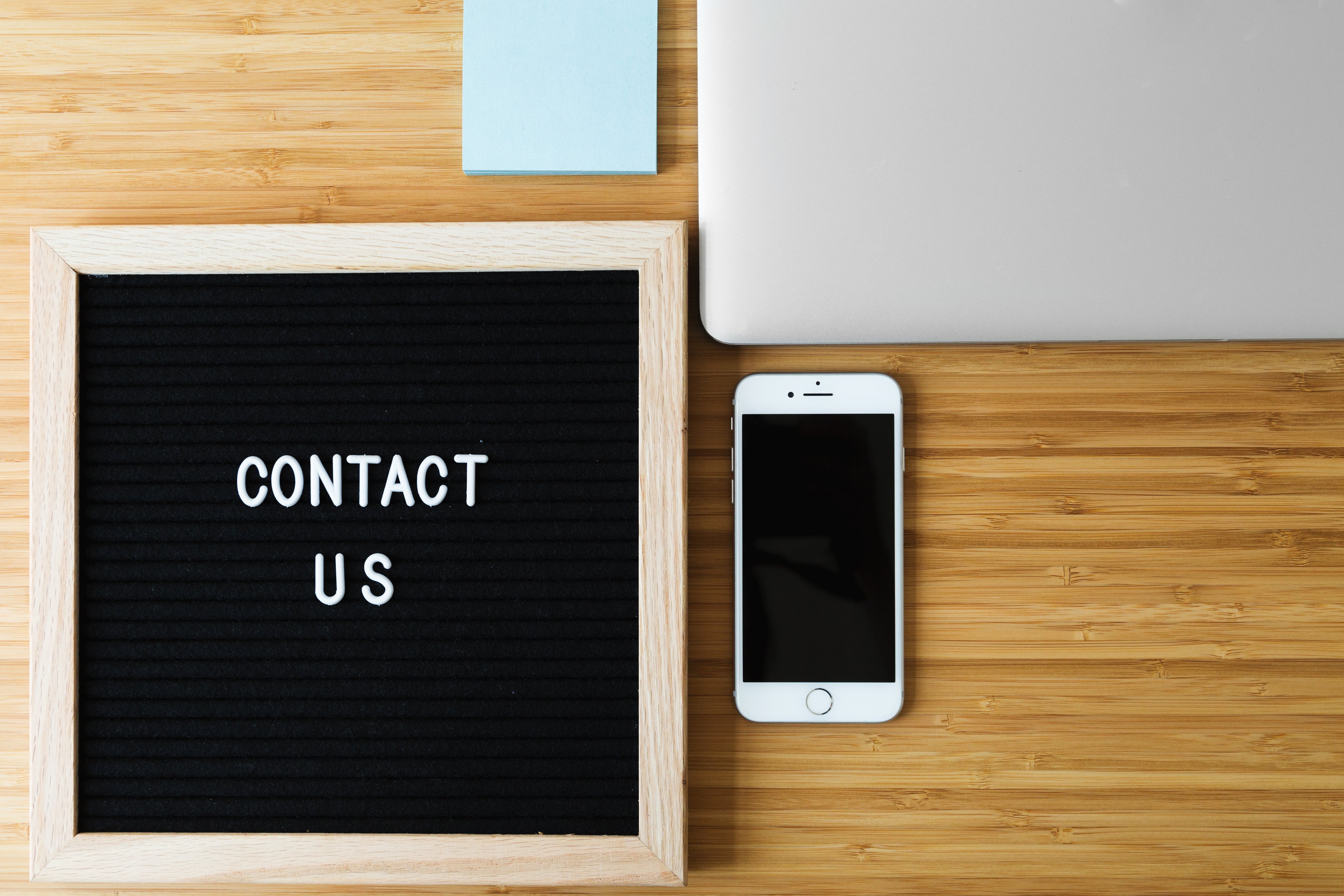 contact-us-sign-with-phone-on-desk.jpg